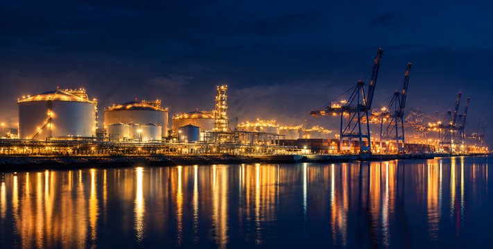Port and energy terminal lit up at night across the water